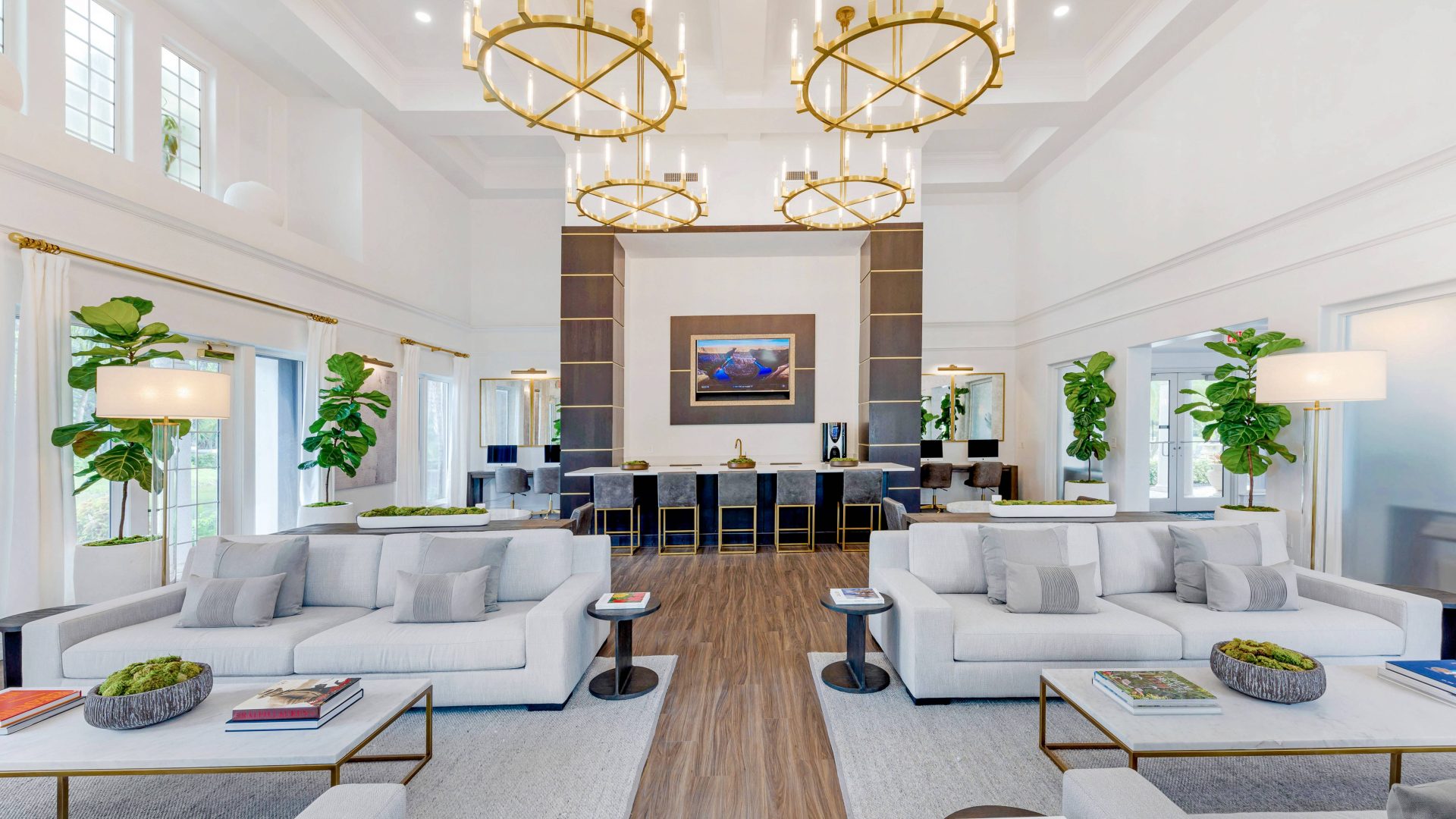 a large living room with white furniture and a chandelier at The Palm Haven